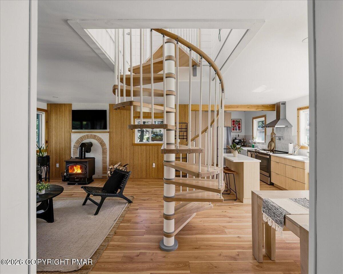 5306 Hummingbird Drive Pocono Summit, PA 18346 - Photo 8 of 32 a living room with furniture a fireplace and wooden floor