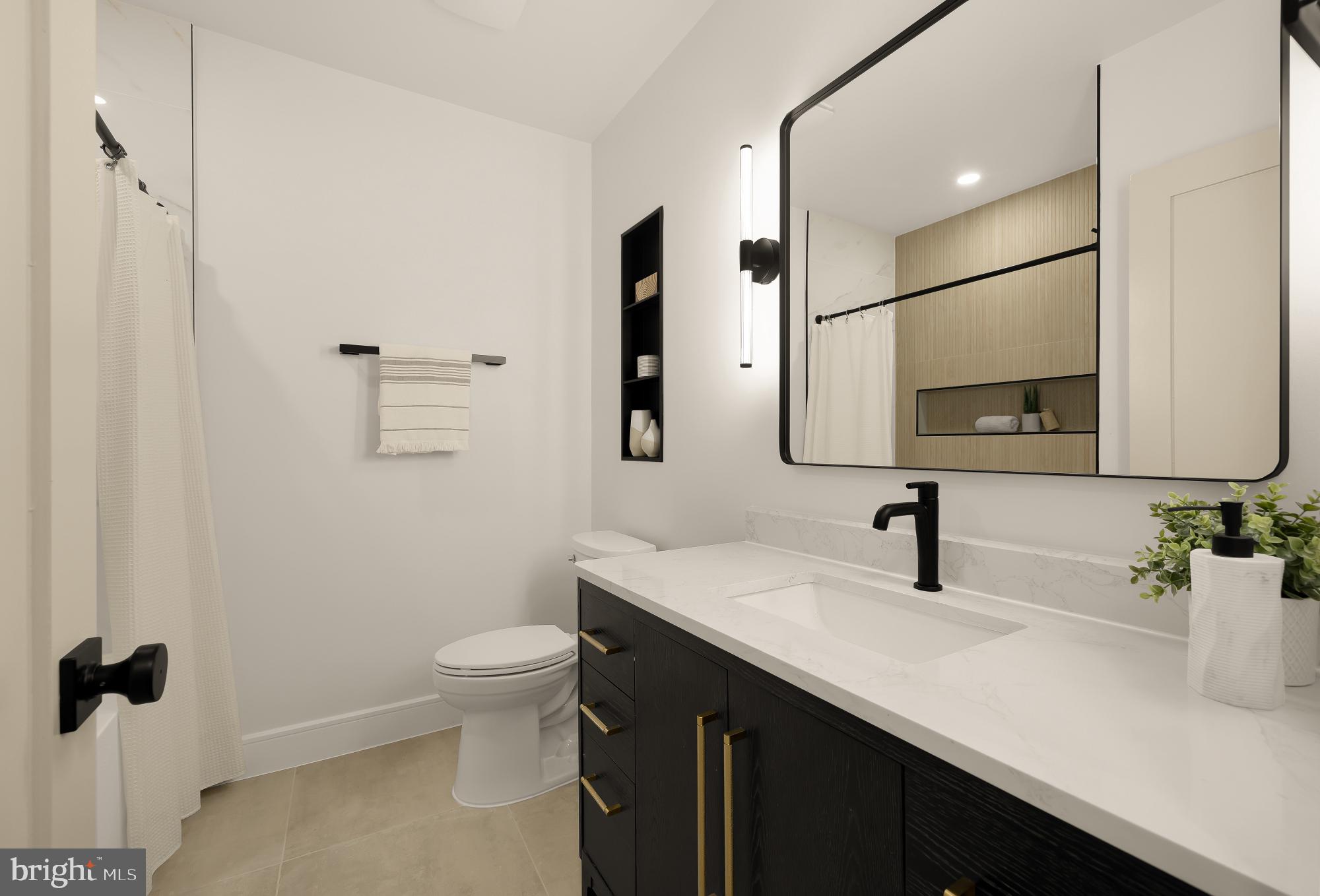 1463 Harvard Street Northwest, Unit 2 Washington, DC 20009 - Photo 16 of 25 a bathroom with a sink toilet and mirror
