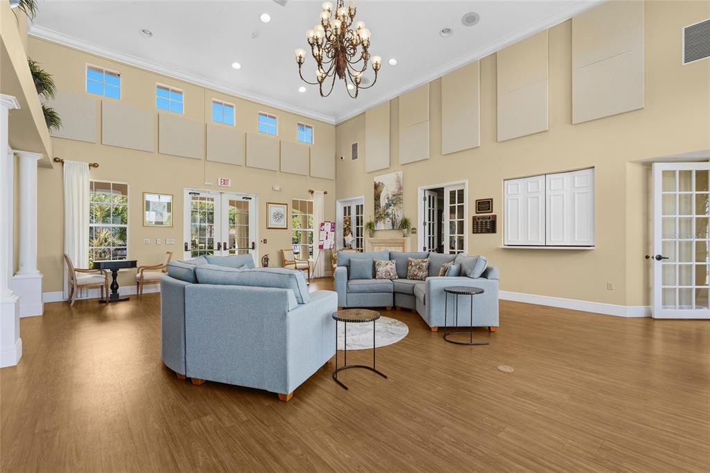 357 Marsh Creek Road Venice, FL 34292 - Photo 68 of 70 a living room with couches and kitchen view with wooden floor