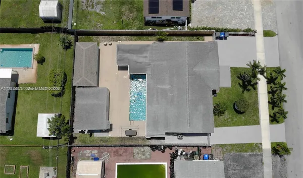 an aerial view of a house with a yard