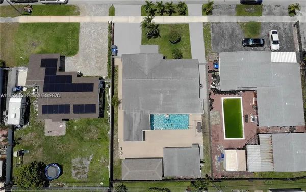 an aerial view of a house with a yard