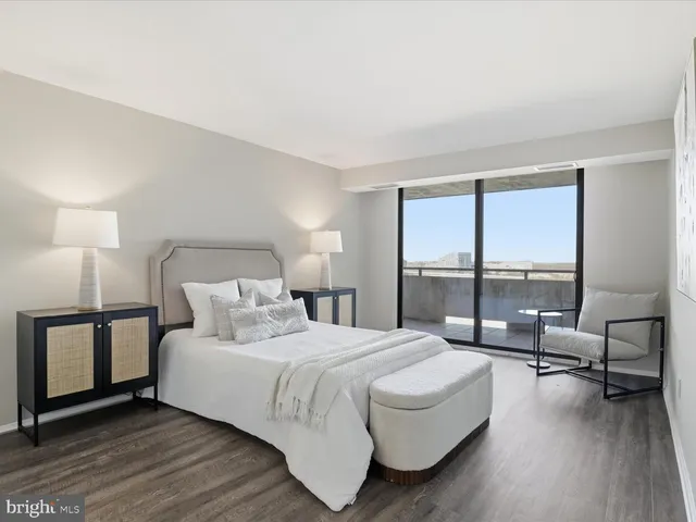 a bedroom with a bed and a large window