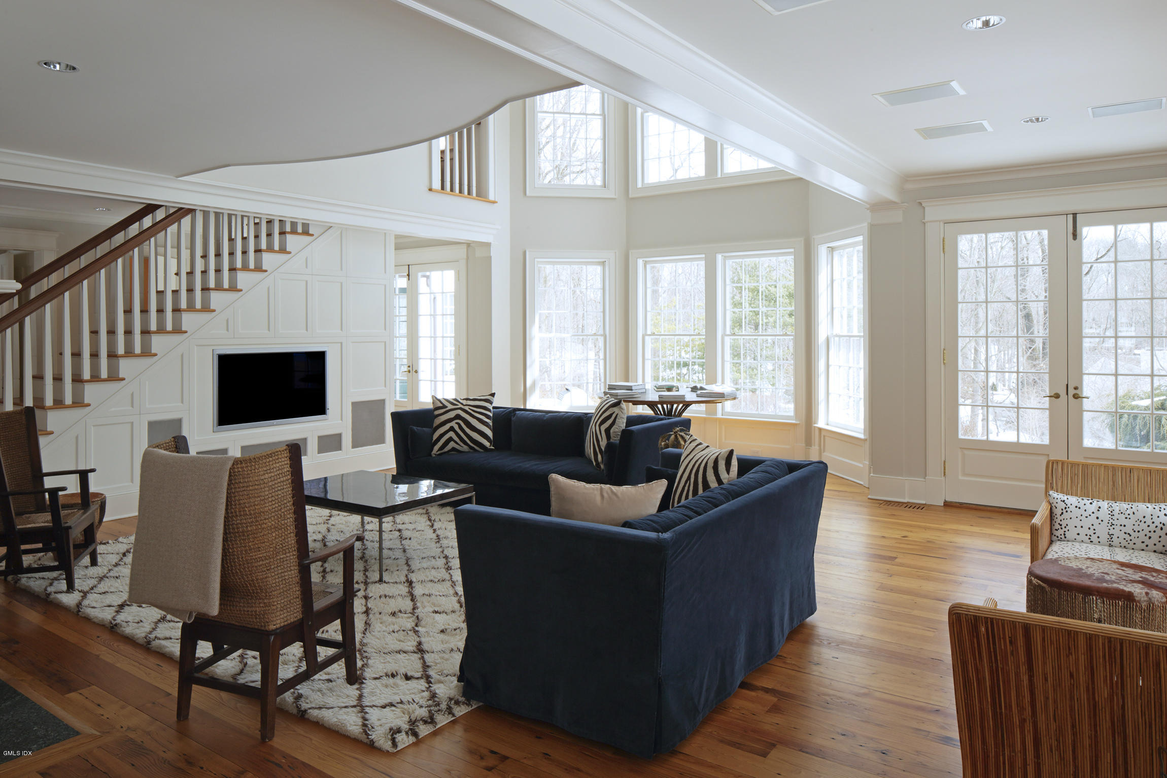 733 Lake Avenue Greenwich, CT 06830 - Photo 4 of 25 a living room with furniture a flat screen tv and a large window