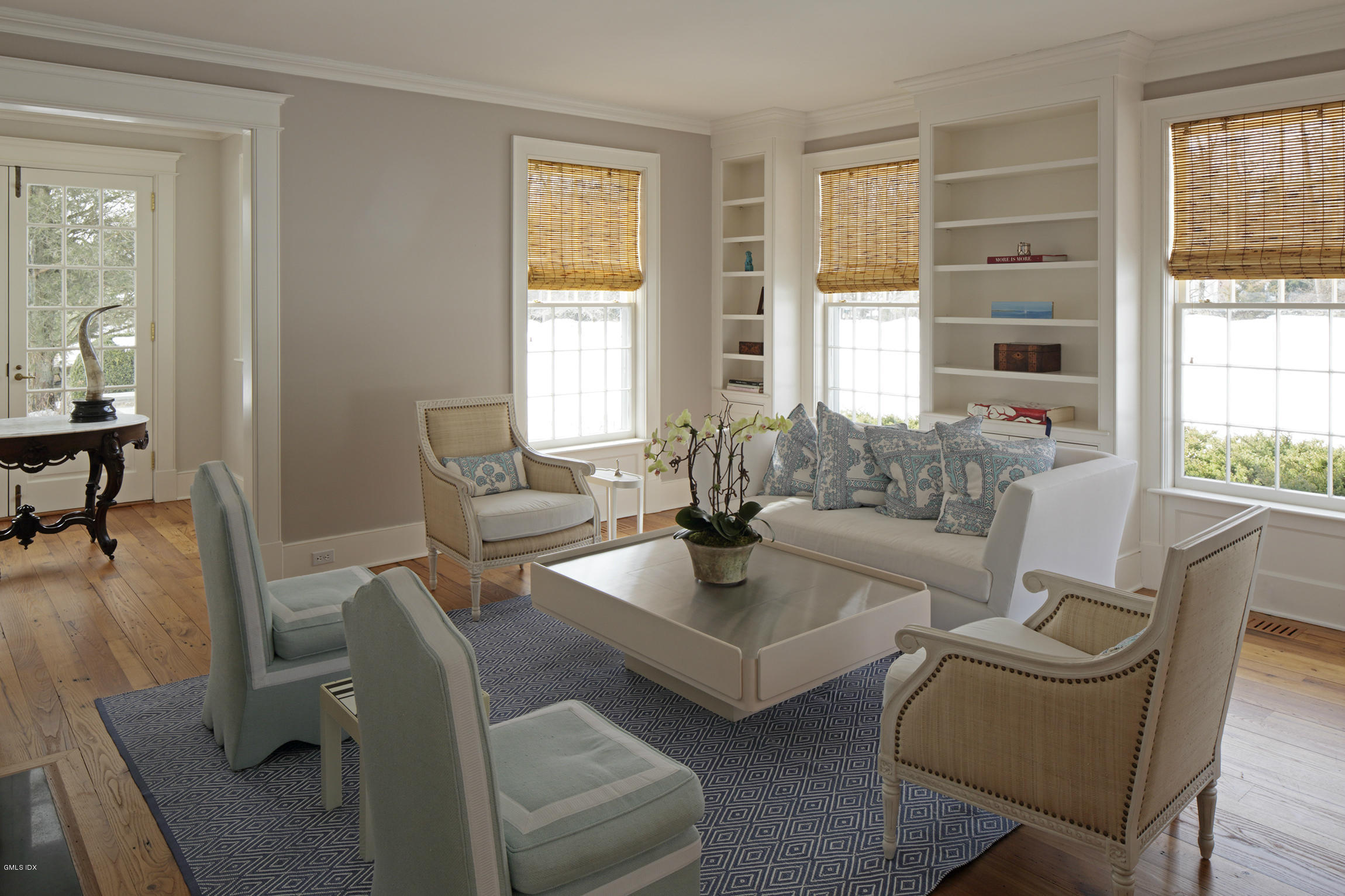 733 Lake Avenue Greenwich, CT 06830 - Photo 7 of 25 a living room with fireplace furniture and a large window