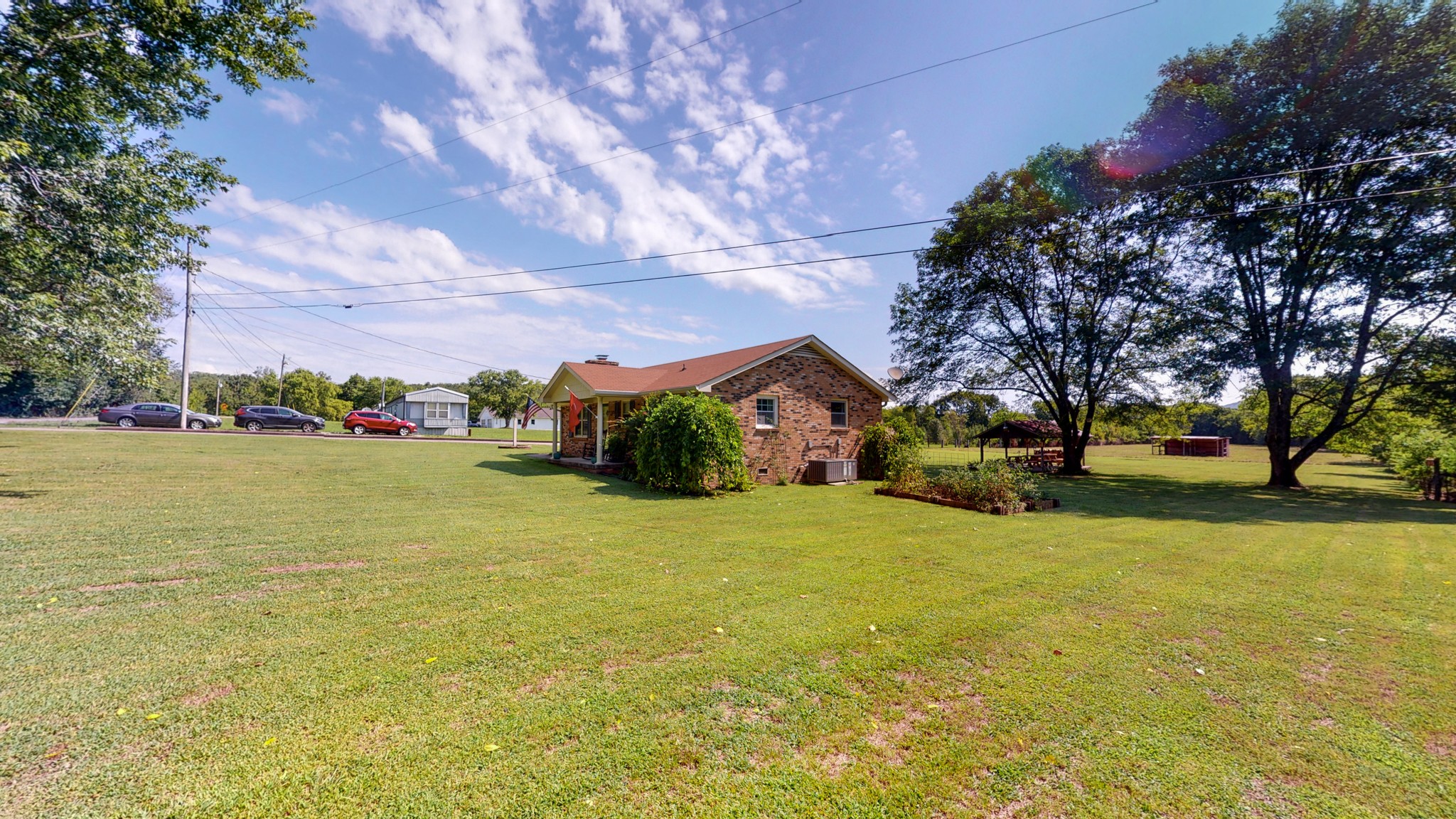 280 Lindsley Road Lebanon, TN 37090 - Photo 4 of 41 a front view of a house with a big yard and a large tree