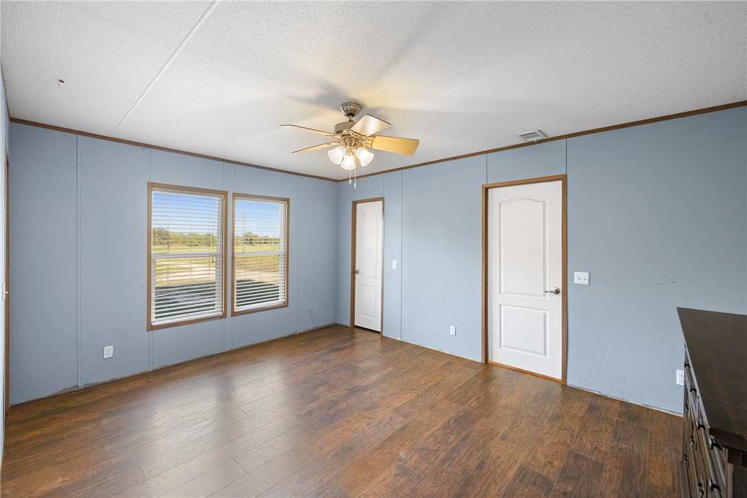 2361 Smetana Road Bryan, TX 77807 - Photo 7 of 32 a view of an empty room with a window and wooden floor