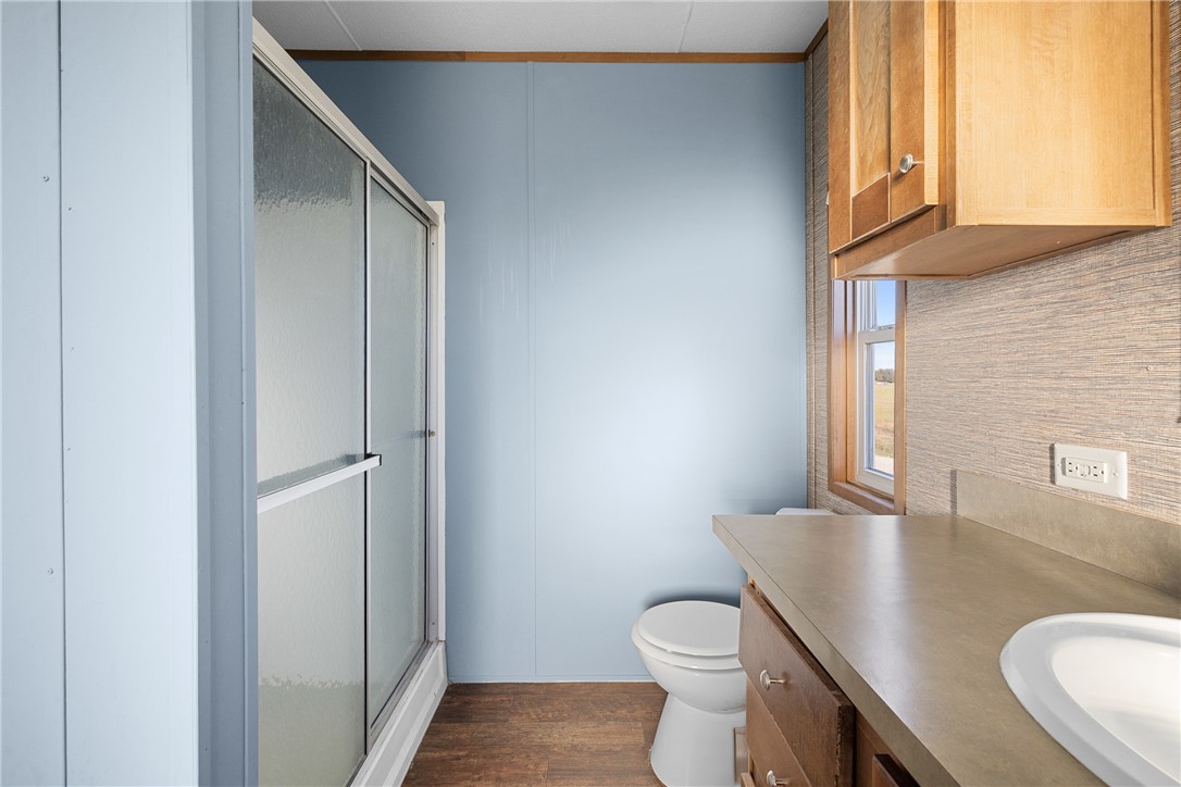 2361 Smetana Road Bryan, TX 77807 - Photo 9 of 32 a bathroom with a granite countertop toilet sink and mirror