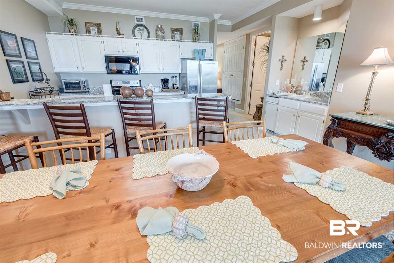 27284 Gulf Road, Unit 213 Orange Beach, AL 36561 - Photo 13 of 40 Wonderful pine wood table w/ seating for 8.