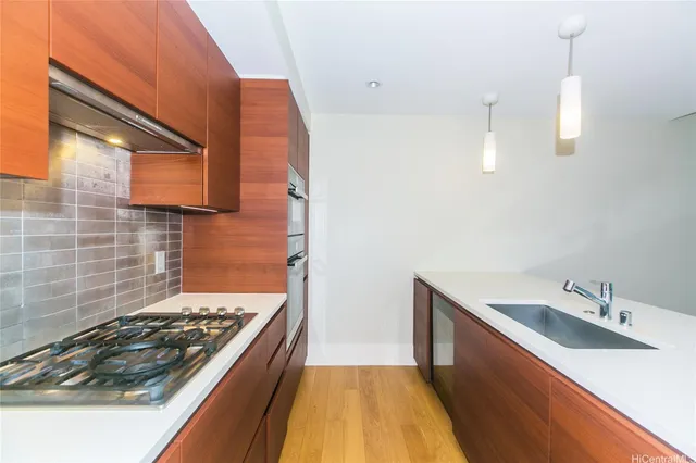 a kitchen with sink stove and cabinets