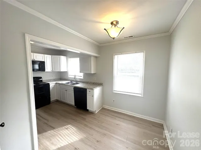 a kitchen with a refrigerator and a stove top oven