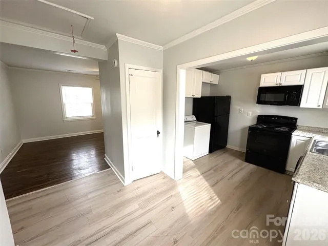 a kitchen with a sink stove and microwave