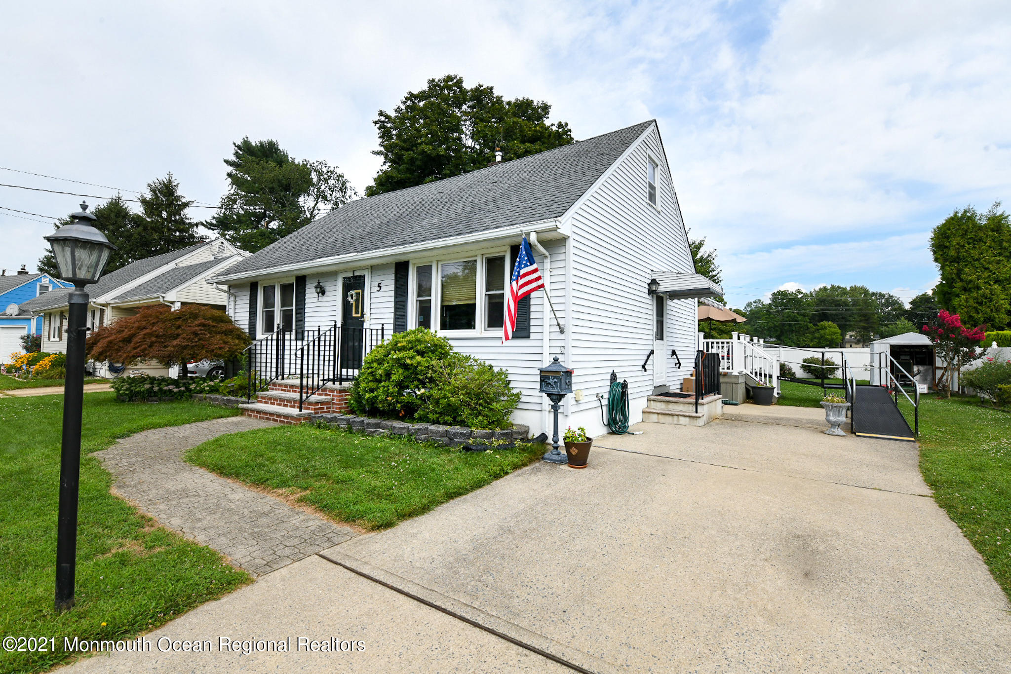 5 Phyllis Road West Orange, NJ 07052 - Photo 3 of 18 a view of a white house with a yard and plants