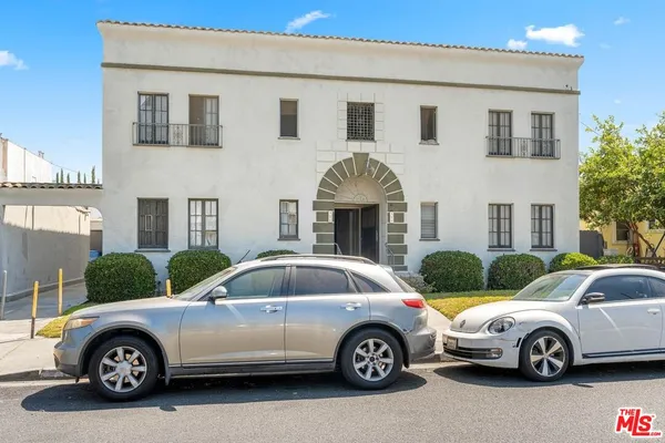 a front view of a house with parking space