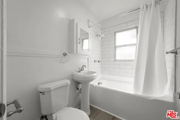a bathroom with a sink toilet and bathtub