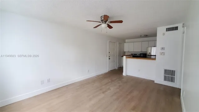a view of a kitchen with a sink dishwasher and a refrigerator