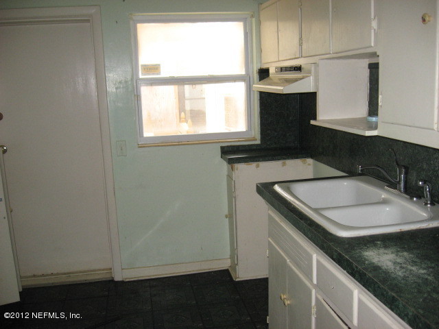 3245 Barkley Road Jacksonville, FL 32246 - Photo 4 of 11 a bathroom with a sink and a window