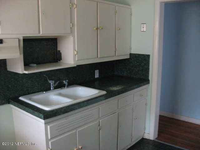3245 Barkley Road Jacksonville, FL 32246 - Photo 5 of 11 a kitchen with a sink and a microwave