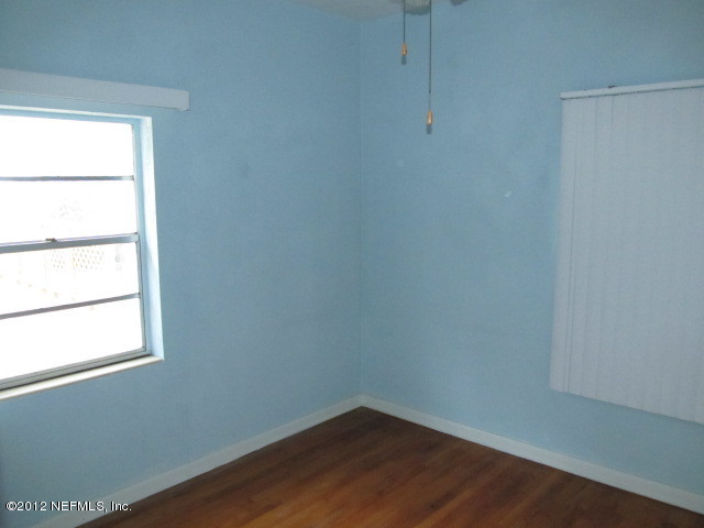 3245 Barkley Road Jacksonville, FL 32246 - Photo 8 of 11 a view of a small space with wooden floor and a window