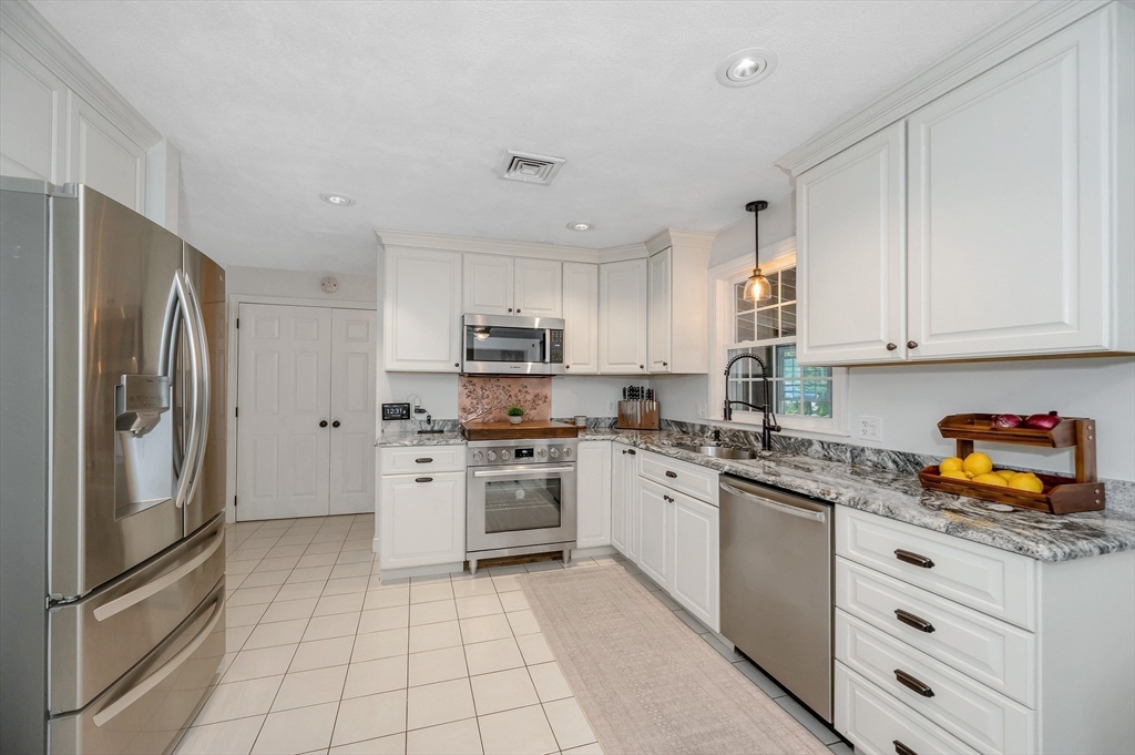 67 Reservation Road Andover, MA 01810 - Photo 13 of 40 a kitchen with stainless steel appliances granite countertop a refrigerator sink and stove