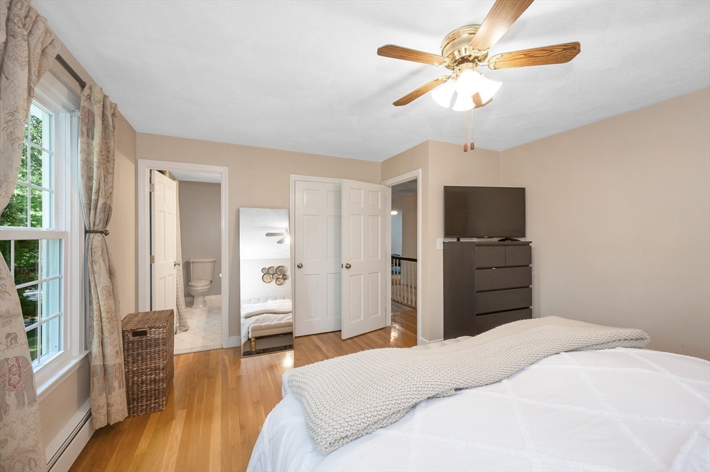 67 Reservation Road Andover, MA 01810 - Photo 21 of 40 a bedroom with a bed and a chandelier