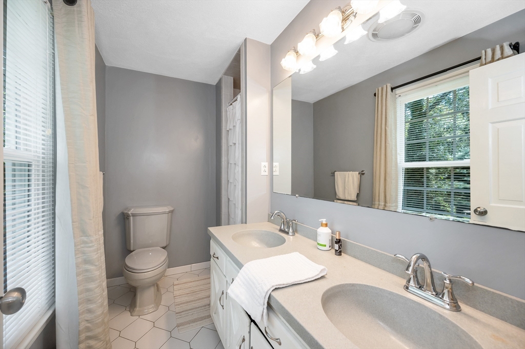 67 Reservation Road Andover, MA 01810 - Photo 22 of 40 a bathroom with a sink a toilet and a mirror