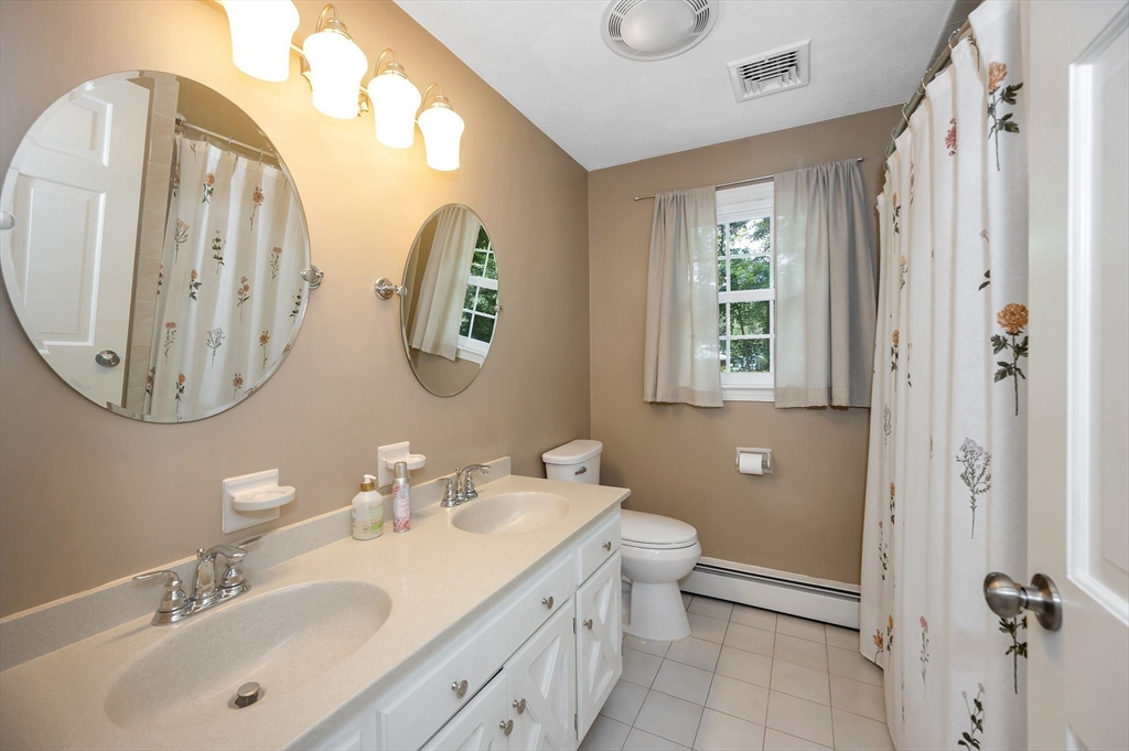 67 Reservation Road Andover, MA 01810 - Photo 25 of 40 a bathroom with a double vanity sink and a mirror
