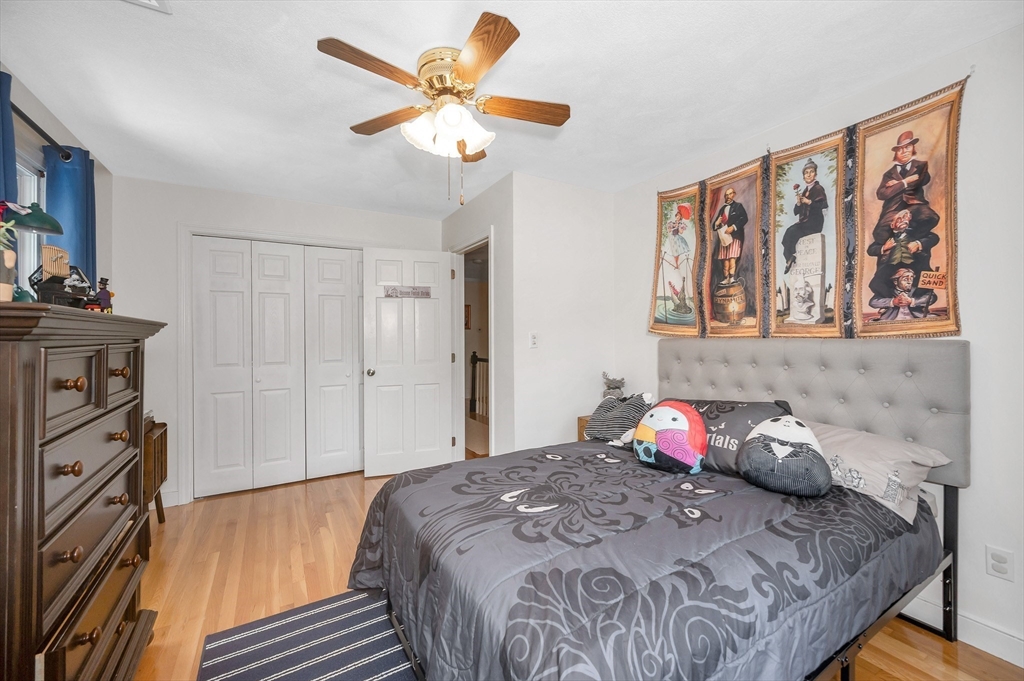 67 Reservation Road Andover, MA 01810 - Photo 28 of 40 a bedroom with a bed and a chandelier