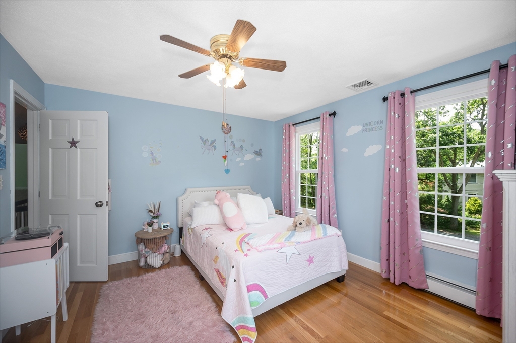 67 Reservation Road Andover, MA 01810 - Photo 29 of 40 a bedroom with a bed and a chandelier