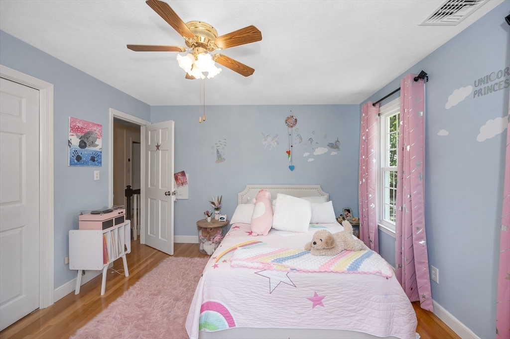 67 Reservation Road Andover, MA 01810 - Photo 30 of 40 a bedroom with a bed and a chandelier