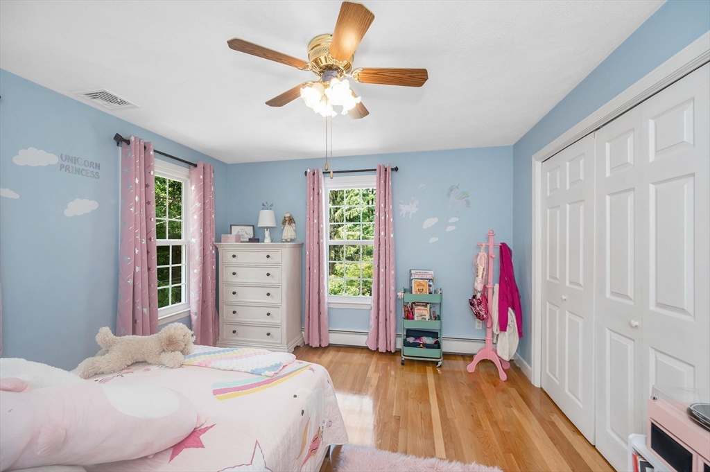 67 Reservation Road Andover, MA 01810 - Photo 31 of 40 a bedroom with a bed and a chandelier