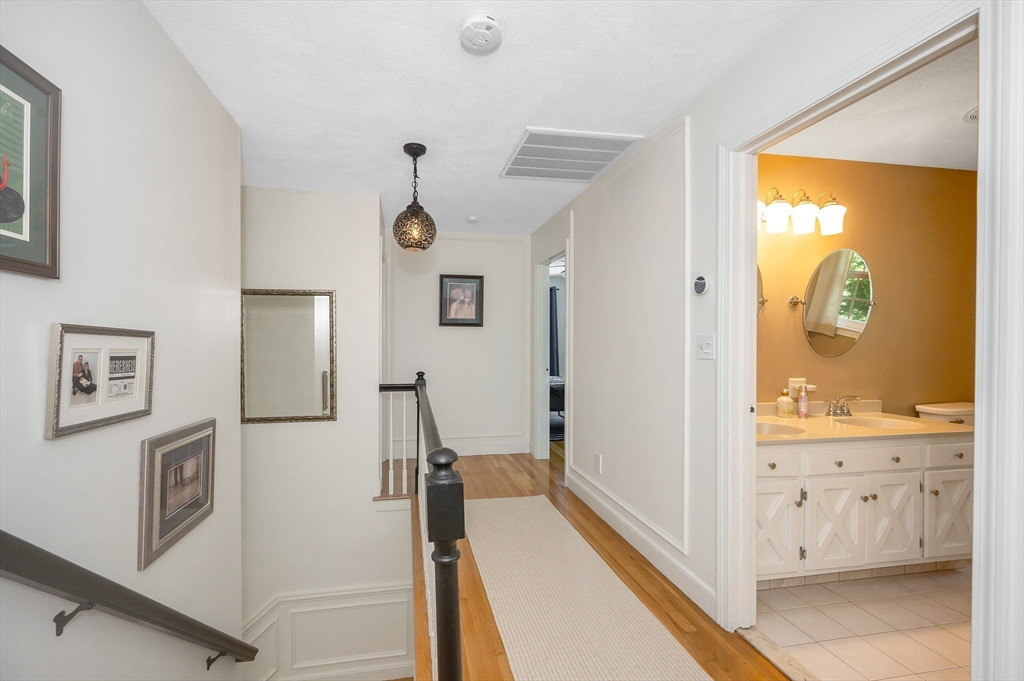 67 Reservation Road Andover, MA 01810 - Photo 32 of 40 a view of a bathroom with a sink and mirror