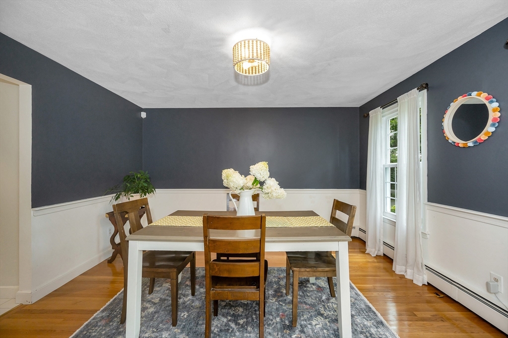 67 Reservation Road Andover, MA 01810 - Photo 8 of 40 a dining room with furniture and a chandelier