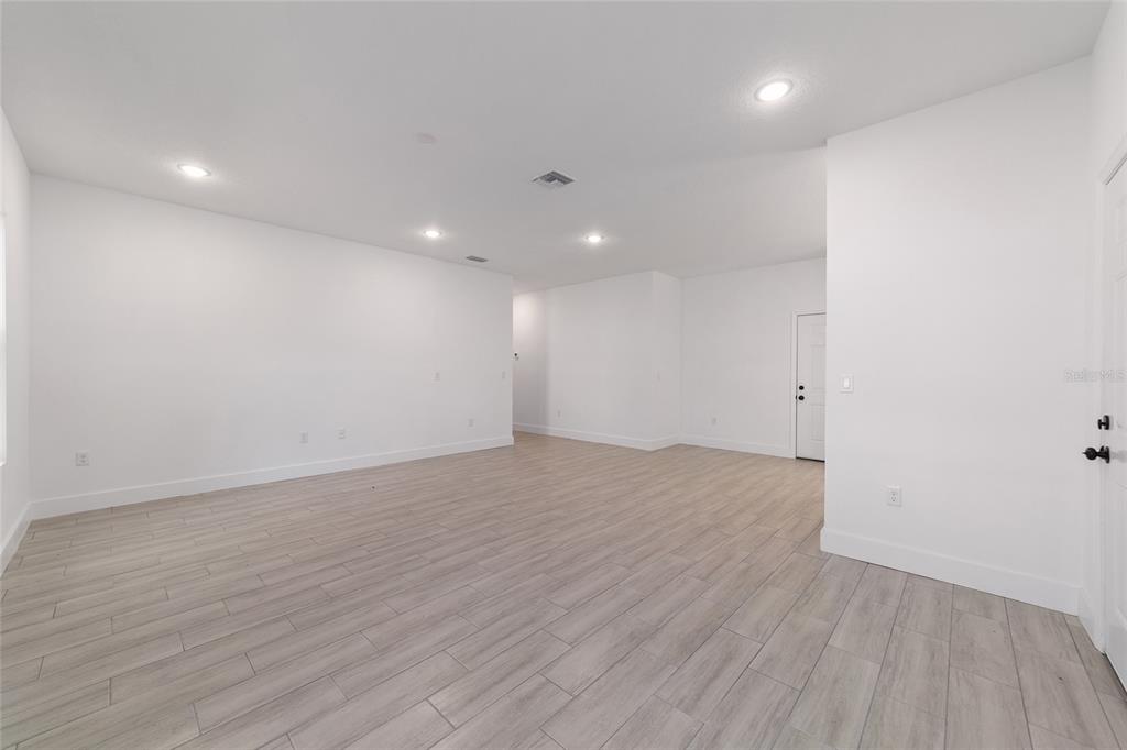 15431 Southwest 41st Street Road Ocala, FL 34481 - Photo 19 of 44 an empty room with wooden floor and windows