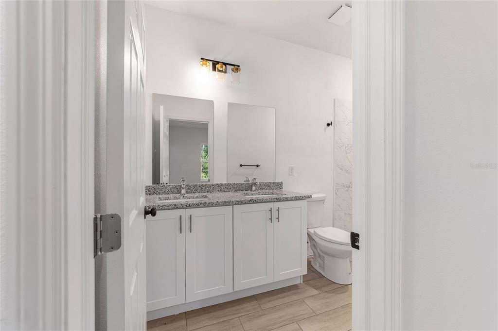 15431 Southwest 41st Street Road Ocala, FL 34481 - Photo 21 of 44 a bathroom with a granite countertop sink and a mirror