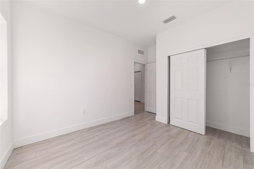 15431 Southwest 41st Street Road Ocala, FL 34481 - Photo 25 of 44 a view of an empty room with wooden floor