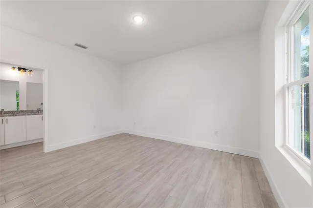wooden floor in an empty room with a window