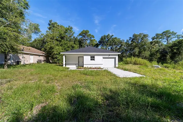 a front view of house with yard and trees