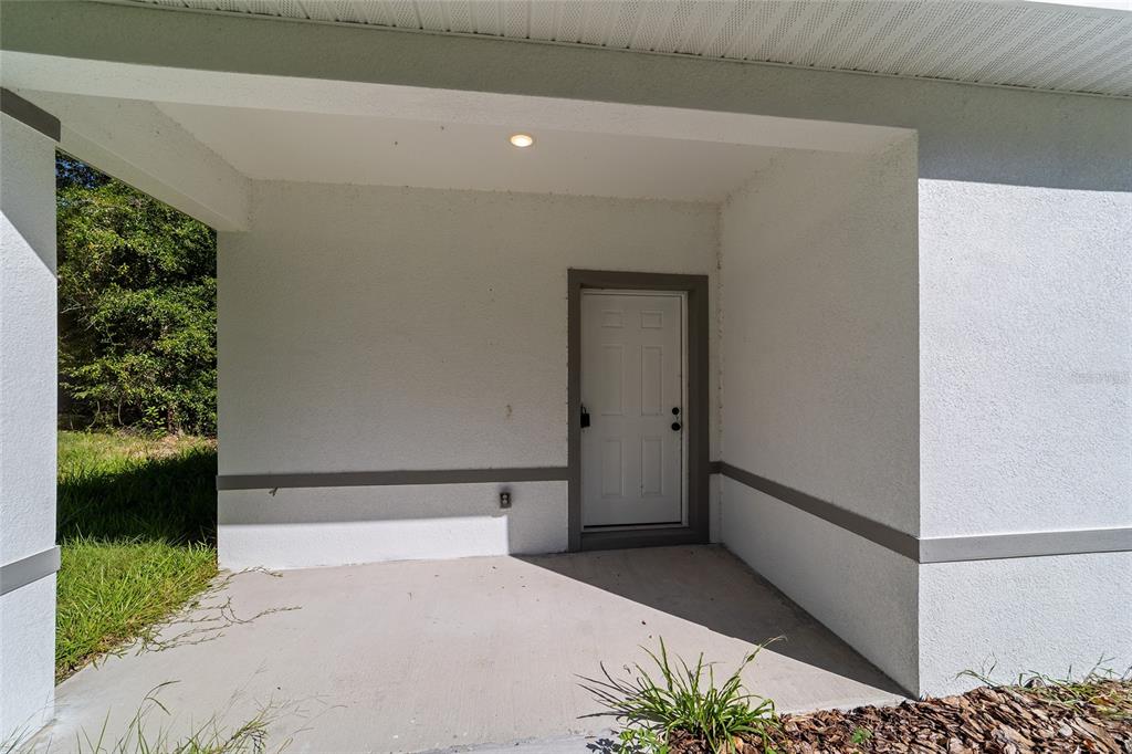 15431 Southwest 41st Street Road Ocala, FL 34481 - Photo 5 of 44 a bedroom with a bed and a potted plant