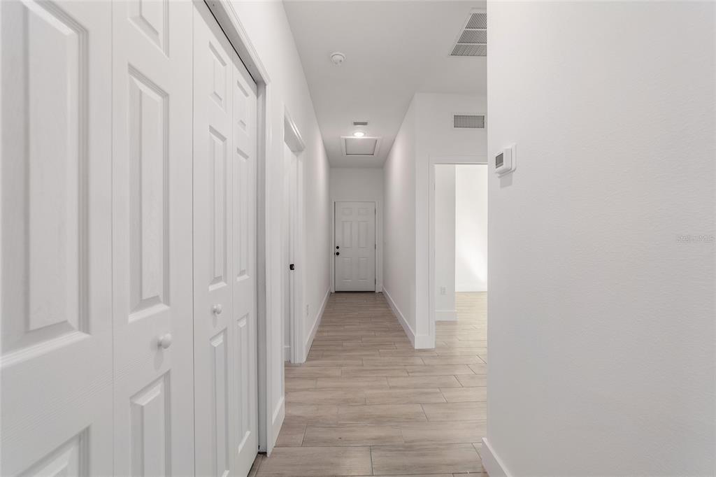 15431 Southwest 41st Street Road Ocala, FL 34481 - Photo 6 of 44 a view of a hallway with wooden floor and staircase