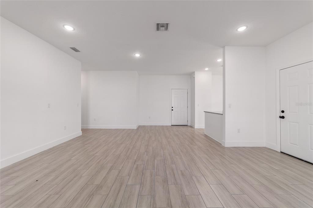 15431 Southwest 41st Street Road Ocala, FL 34481 - Photo 8 of 44 an empty room with wooden floor