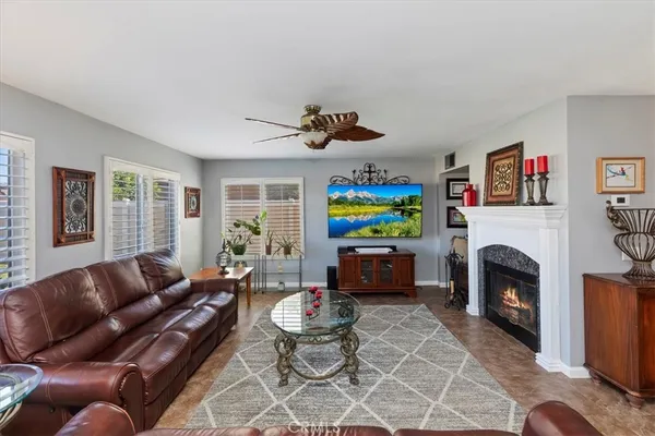 a living room with furniture a fireplace and a flat screen tv