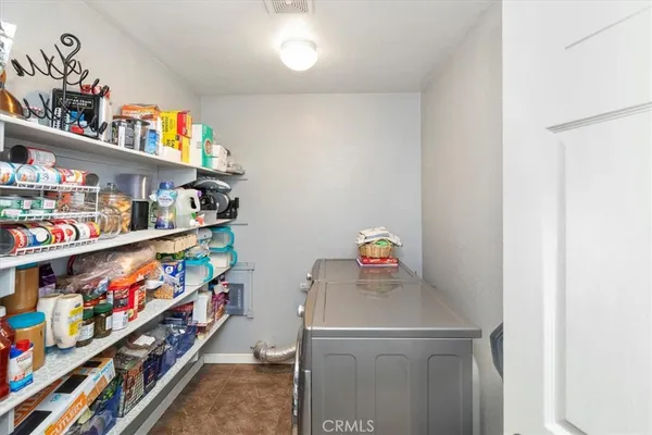 a room with a refrigerator and a window