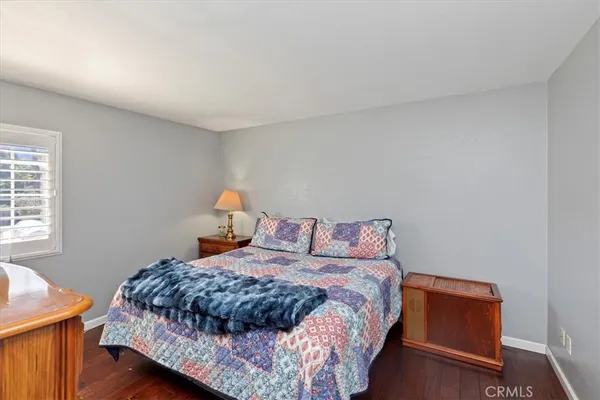 a bedroom with furniture and a flat screen tv