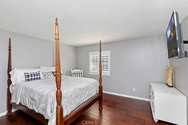 a bedroom with a large bed a couch and a window