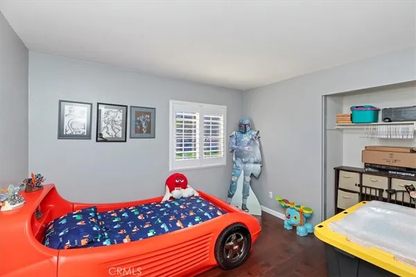 a bedroom with furniture and a dresser