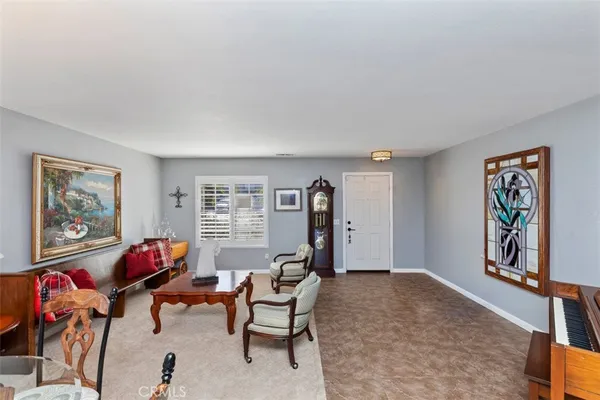 a living room with furniture a window and a flat screen tv