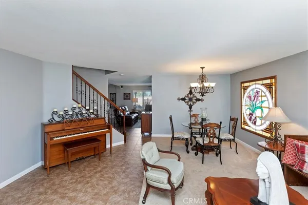 a view of a dining room with furniture wooden floor and a chandelier