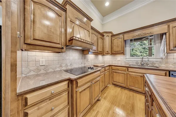 a kitchen with stainless steel appliances granite countertop a sink and cabinets