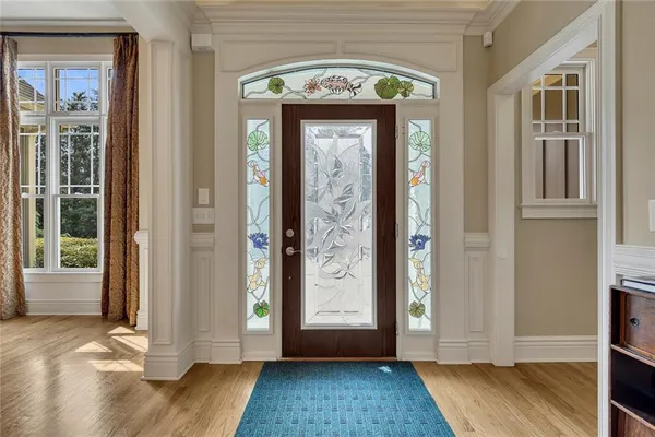 a view of an entryway with wooden floor and a livingroom