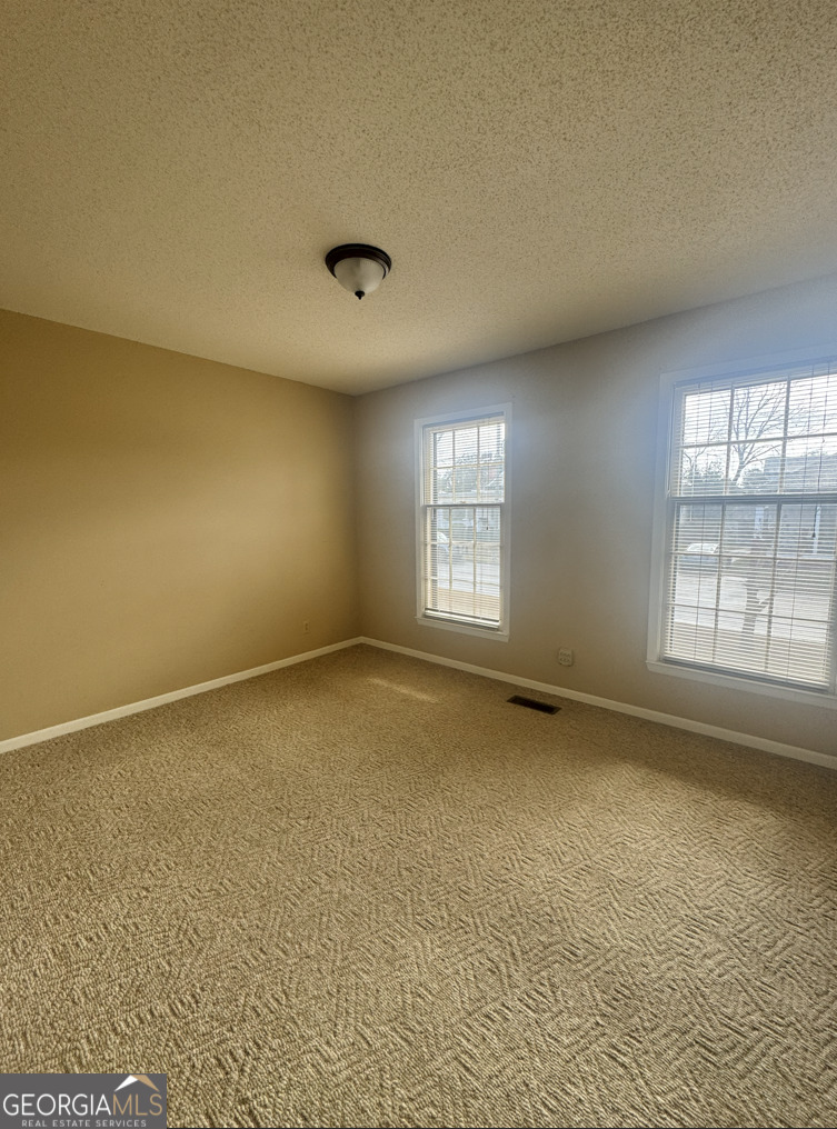 301 Church Street Vienna, GA 31092 - Photo 4 of 12 an empty room with a window